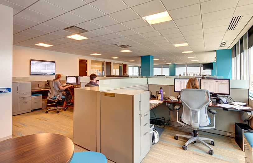 Cubicles with low glass partitions to minimize transmission but allow for openness